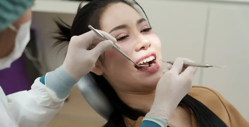 Person at the dentist office having their teeth examined.