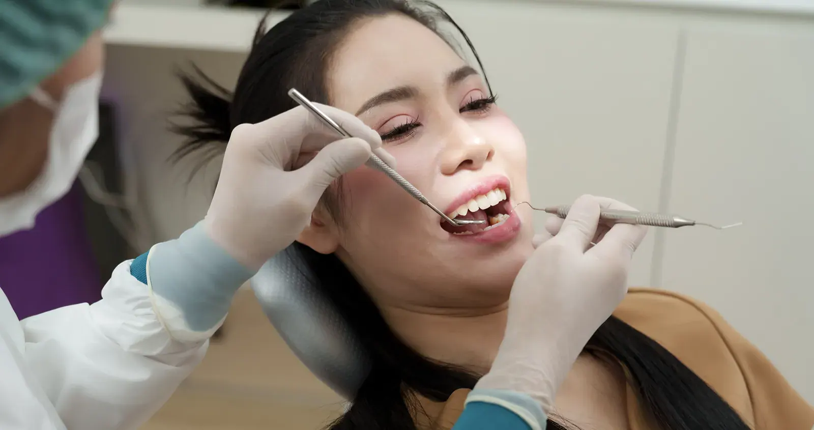 Person at the dentist office having their teeth examined.