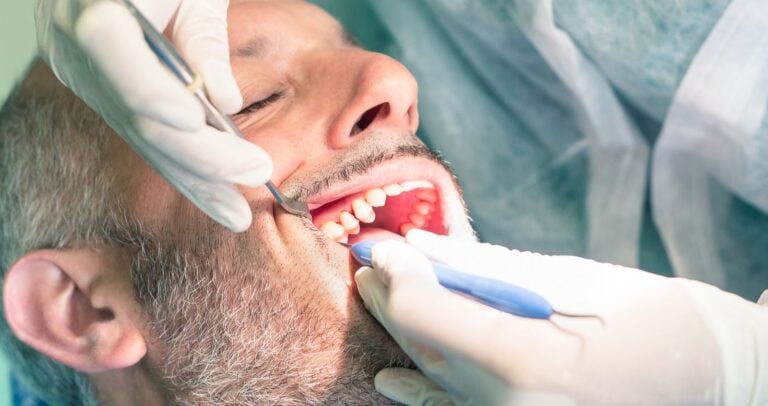 Person in dental office having their teeth worked on.
