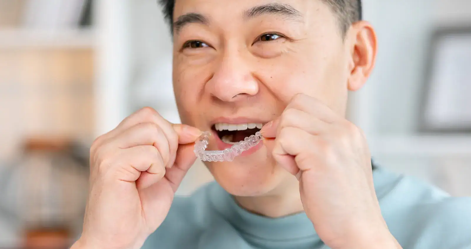 Person at the dentist's office adjusting their Invisalign aligners.